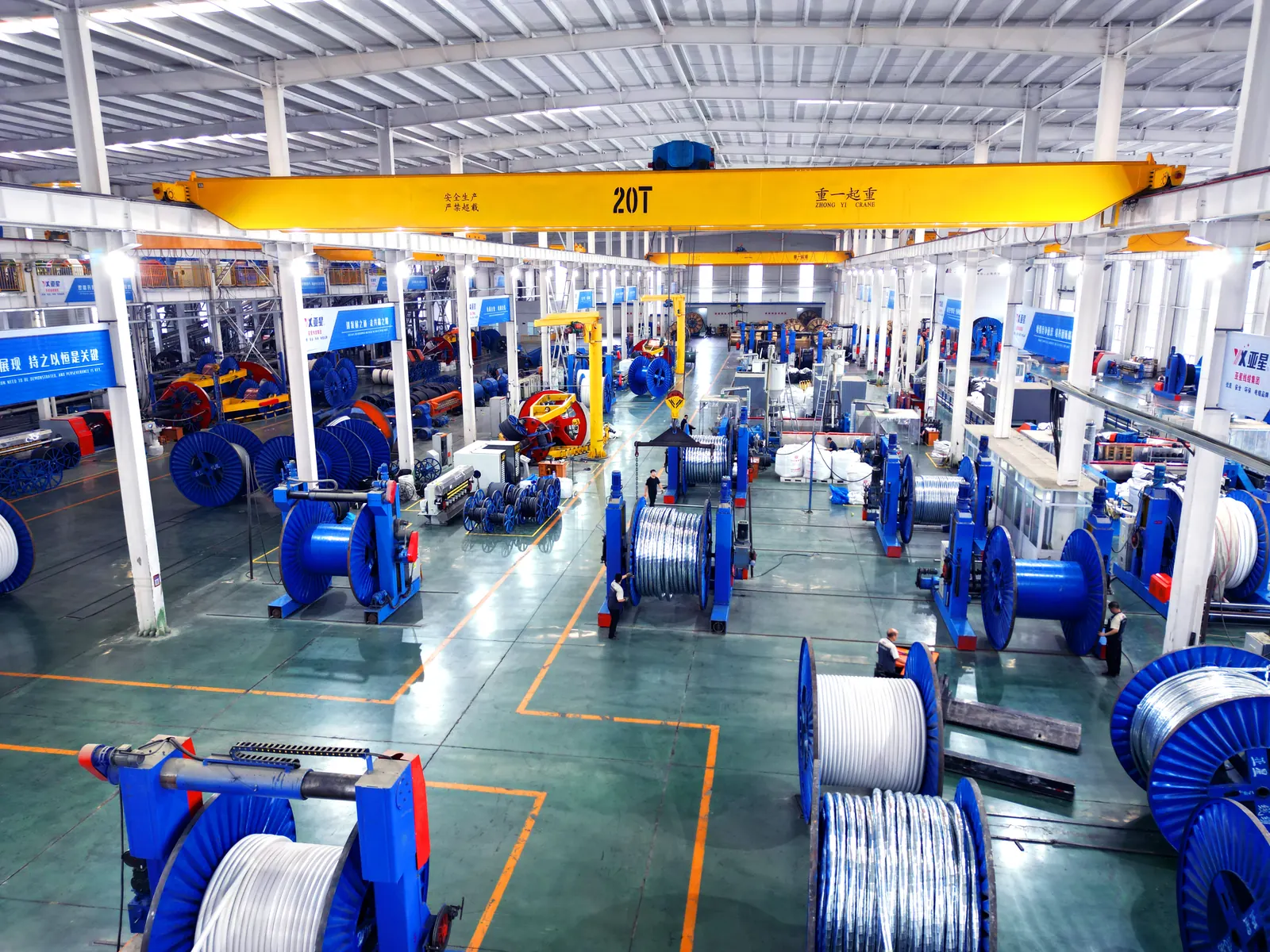 Elevated view along a Yaxing production hall with cable drums and an overhead travelling crane